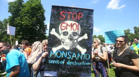 Protesters march with signs raised through Zagreb in a protest against US biotec Stock Footage 63862124