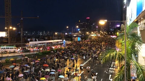 Protesters marching on highway to Central under heavy rain neglecting police ban Stock Footage 116322166
