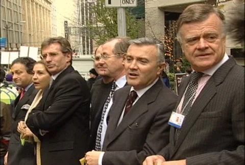 Protesters Marching Past Men in Suits at WTO Protests Stock Footage 106904148