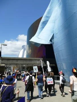 Protesters marching with signs in front of the Museum of Pop Culture in Sea.. Stock Photos