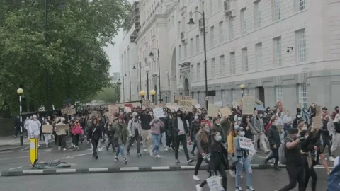 Protesters marching through London Streets, chanting "Black Lives Matter" Stock Footage 132107259
