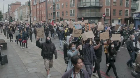 Protesters marching through London Streets, chanting "Black Lives Matter" Stock Footage 132107526