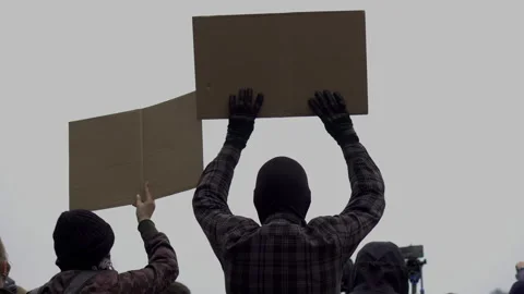 The protesters with posters in their hands. Close-up of people silhouettes  Video stock 131953401