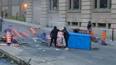 Protesters putting gaz in fire Stock Footage 132482770