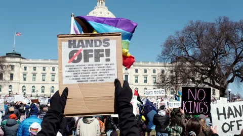 Protesters raise "HANDS OFF!" signs listing at a massive "No Kings" rally at Stock Footage 333021505