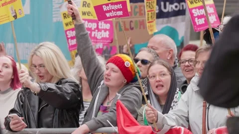 Protesters Rally in Support of Refugee Rights and Against Far-Right Hate Stock Footage 318278287