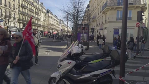 Protesters red flags walking along street of Paris, France Stock Footage 305730750
