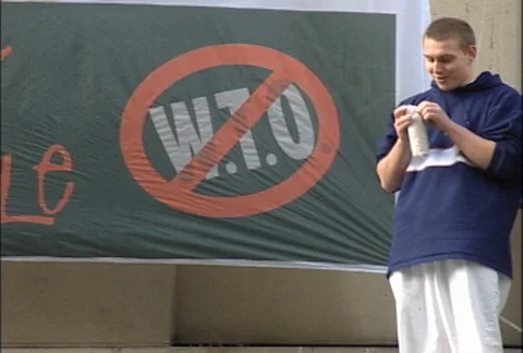 Protesters on Rooftop Next to Don't Trade On Me Sign at WTO Protests Stock Footage 106799942