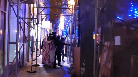 Protesters running in the direction of the camera in a close space Stock Footage 87268763