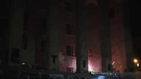 Protesters shoot fireworks and laser beams at parliament building Video stock 298007142