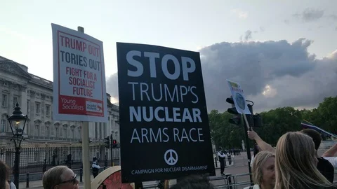 Protesters with signs staying STOP TRUMPS NUCLEAR ARMS RACE, UK, 4K Stock Footage 109205139