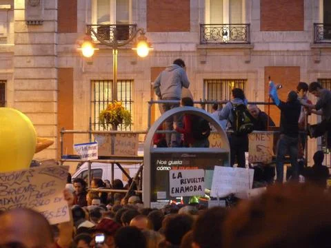 Protesters standing on top of scaffolding Stock Photos