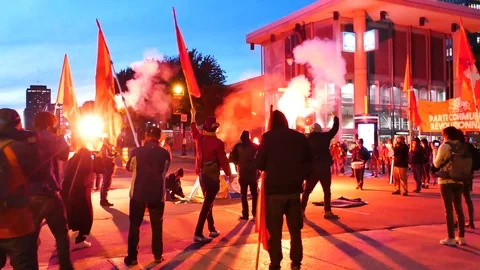Protesters starting fire in the middle of the street Stock Footage 99842354