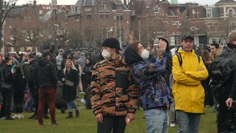 Protesters taking selfies at corona demonstration. Amsterdam, Netherlands. Stock Footage 147399099