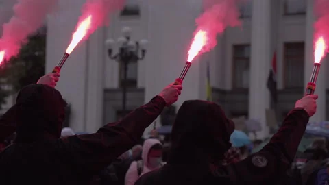 Protesters in their hands holding burning fires. Hands with flaming and smoking  Stock Footage 131953585