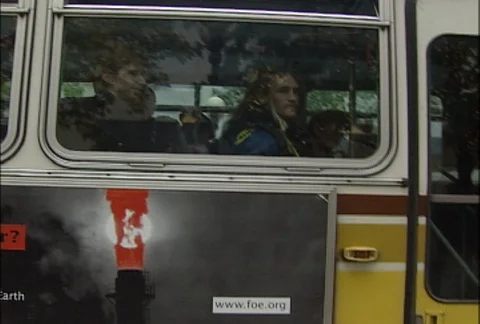 Protesters Through Bus Window at WTO Protests Stock Footage 106818995