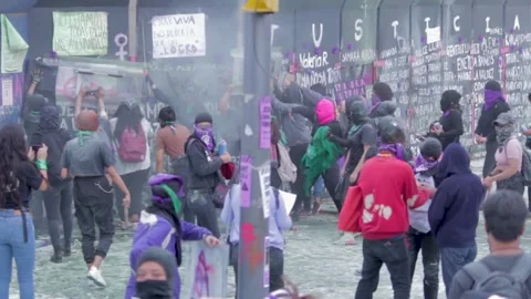 Protesters throw flames to police during march on International women's day Stock Footage 154014159
