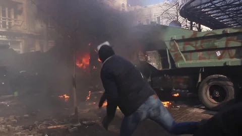 Protesters throw stones. Smoke. burning barricades. Riot in Kiev Stock Footage 73165137
