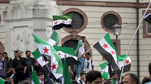 Protesters waving Syrian Flags in opposition to Assad Regime - Migrant Crisis Stock Footage 79732112