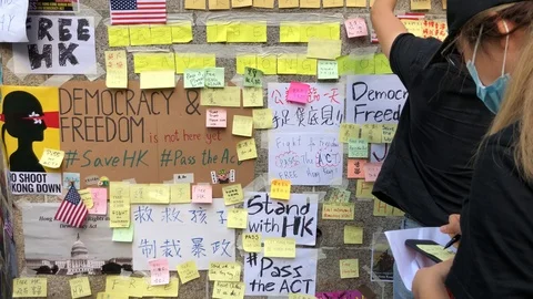 Protesters writing sticky notes outside US consulate. Stand with HK. Free HK. Stock Footage 115706921
