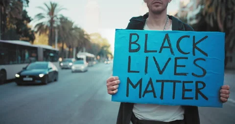 Protesting activist white man holding hands carton poster with the slogan Black 스톡 동영상 140969053