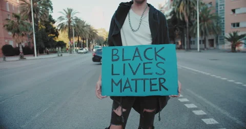 Protesting caucasian man activist holding hands poster with the slogan Black Video stock 140968604