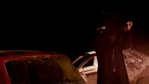 Protesting guy in Balaclava smashes the back window of car with baseball bat Video stock 138655074