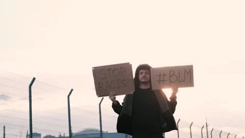 Protesting guy holds a poster with the inscription over his head - BLACK LIFE Stock Footage 132997975