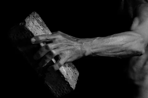 Protesting man throws a brick. Stock Photos