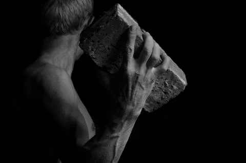 Protesting man throws a brick. Foto stock