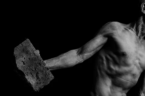 Protesting man throws a brick. Stock Photos