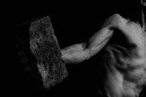 Protesting man throws a brick. Stock Photos