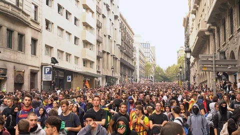 Protesting people with flags of Catalonia on a blocked street in Barcelona. Stock Footage 118235227