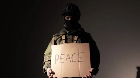 Protesting war conflict raises banner with inscription massage text PEACE on Stock Footage 278289651