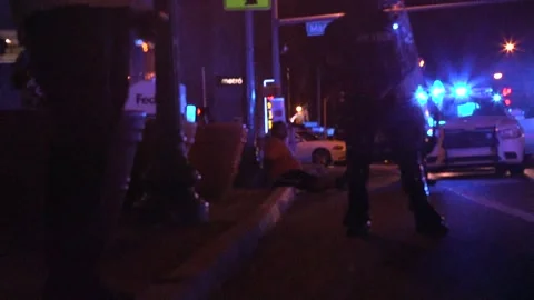 Protestor arrested sitting on curb Stock Footage 136127307
