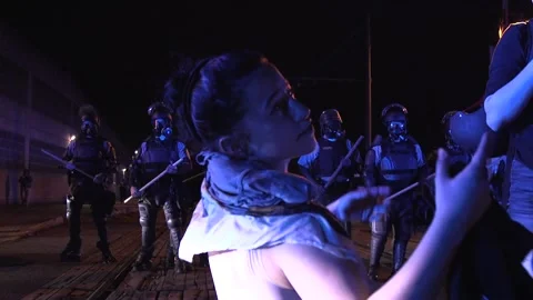 Protestor gets help rinsing her eyes Stock Footage 136127494