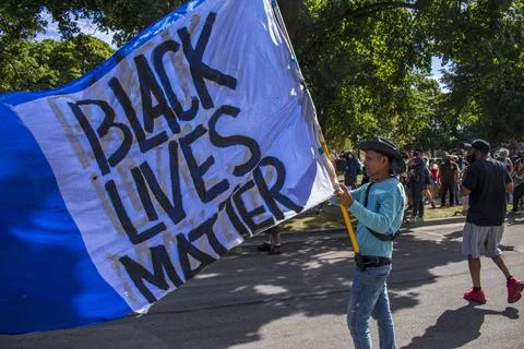 Protestor with large BLM flag Stock Photos