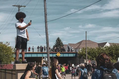 Protestor standing on wall Stock Photos