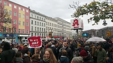 Protestors assemble at Hermannplatz  for “me too” demonstration, signs, umbrella Vídeos de archivo 81855973