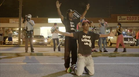 Protestors fall to their knees to oncoming police in the Ferguson riots. Stock-Footage 45457430