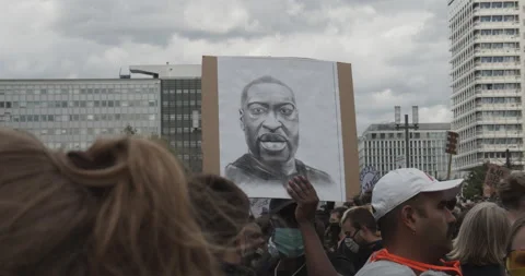 Protestors holding up sign with face of George Floyd against Police Brutality Stock Footage 132136994