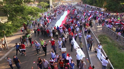 Protestors march and carry a large flag in Cairo, Egypt Stock Footage 25486380