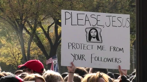 Protestors at a rally hold signs urging Jesus to protect them Stock Footage
