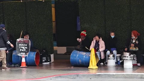 Protestors on Strike Banging Drums in Downtown Stock Footage 302947235
