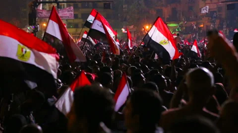 Protestors wave the Egyptian flag in Cairo, Egypt at a large rally. Stock Footage 34436770