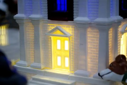 Prototype printed on 3D printer brick building with columns and glowing windows Fotos de archivo