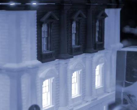 Prototype printed on 3D printer brick building with columns and glowing windows Fotos de archivo