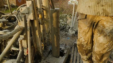 From the protruding pipe, mud splashes out along the walls of the pipe Stock Footage 122080612