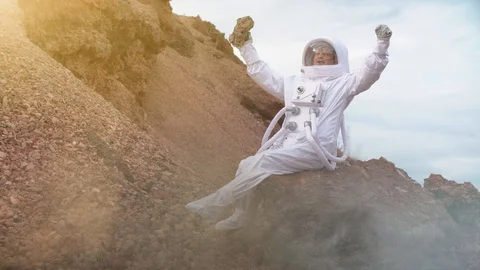 Proud Astronaut on Mars Surface. Red Planet covered rock Stock Footage 111373156