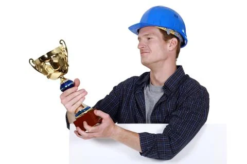 Proud builder holding trophy Stock Photos